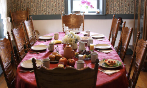 photo of dining room table and chairs with table settings